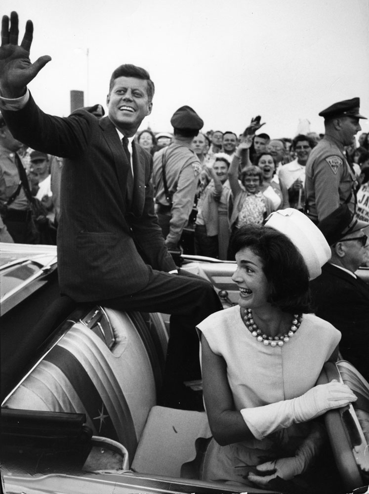 John F. Kennedy rides in a car with his wife Jackie upon his return home from Democratic National Convention in 1960.