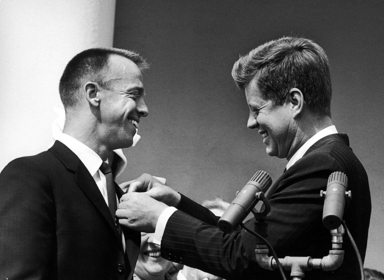 President John Kennedy pins NASA's Distinguished Service Medal on Alan Shepard's chest, 1961.