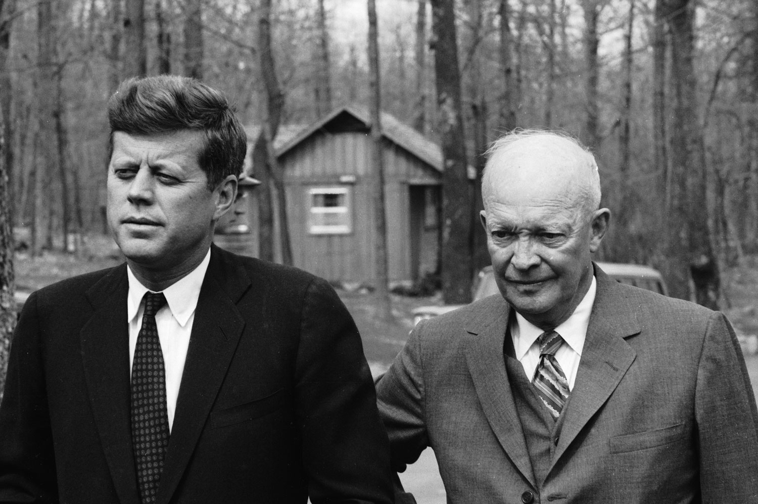 President John F. Kennedy meets with former President Dwight Eisenhower at Camp David in the midst of the Bay of Pigs crisis, 1961.