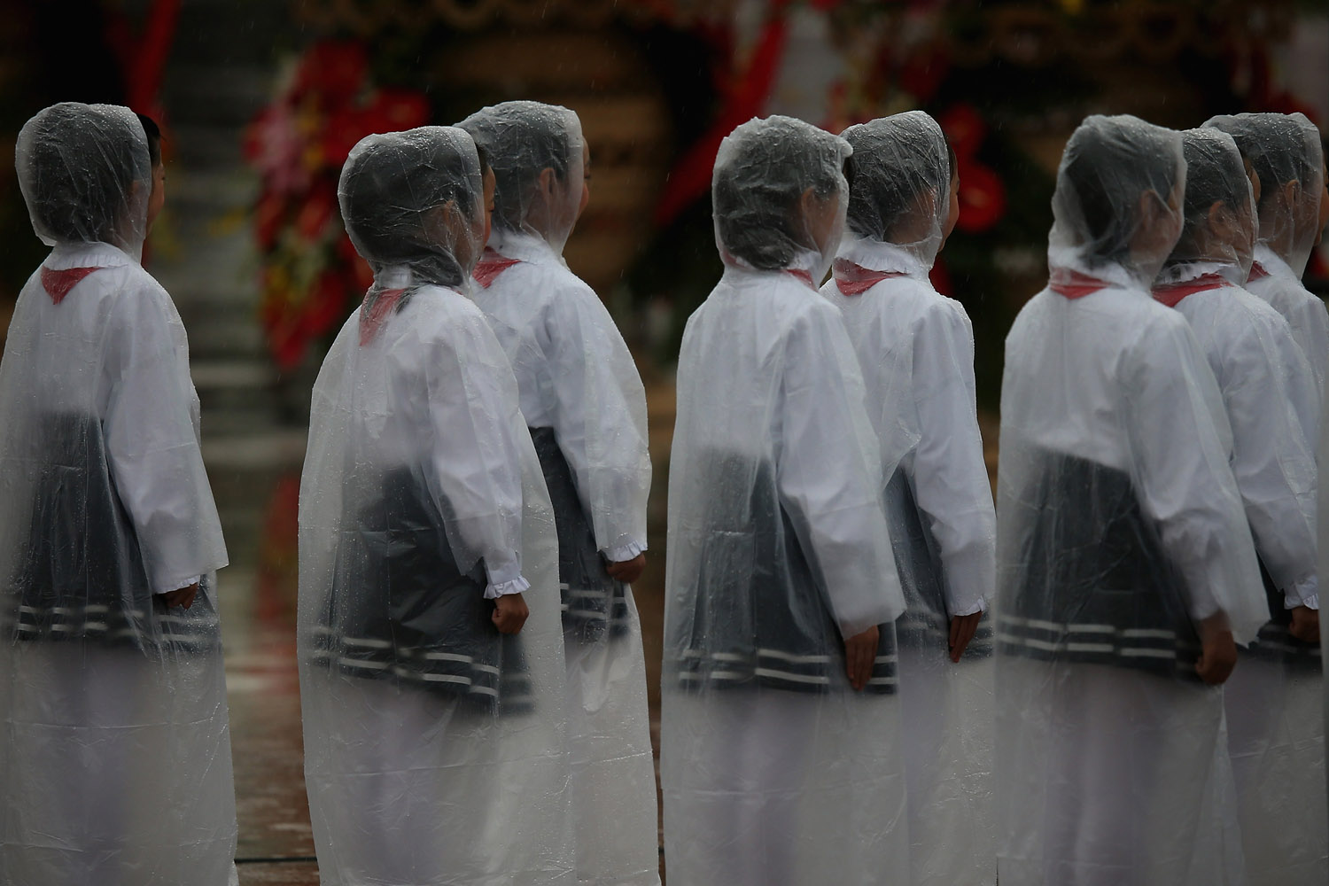 Oct. 1, 2013. Chinese students wearing raincoats perform for a tribute ceremony marking the 64th anniversary of the founding of the People's Republic of China at Tiananmen Square in Beijing.