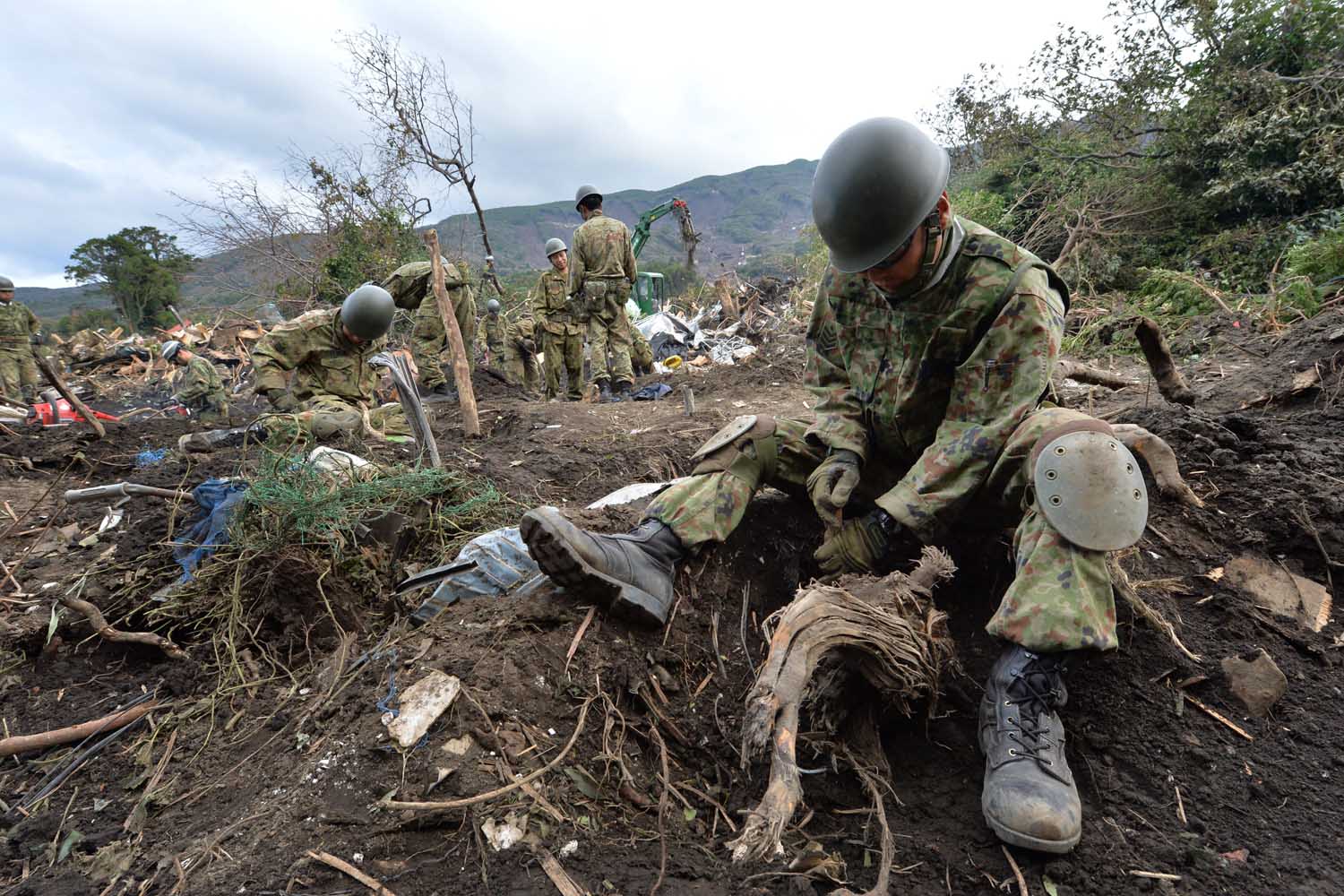 Oct. 18, 2013. Ground Self-Defense Force troops search for missing people after a landslide on Oshima Island.