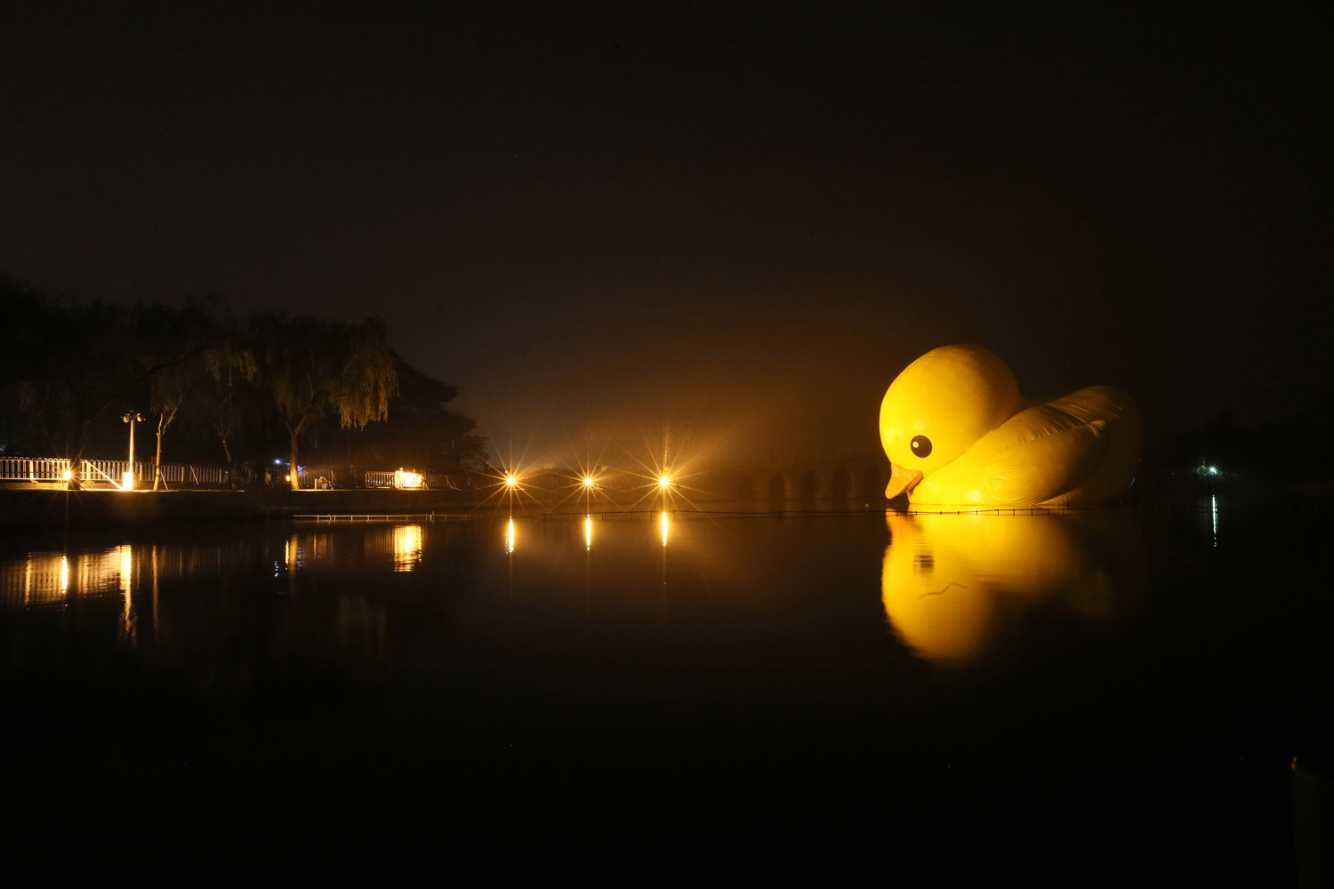 Oct. 27, 2013. A giant, inflatable  Rubber Duck  designed by Dutch conceptual artist Florentijn Hofman is uninstalled at the Summer Palace  in Beijing, China.