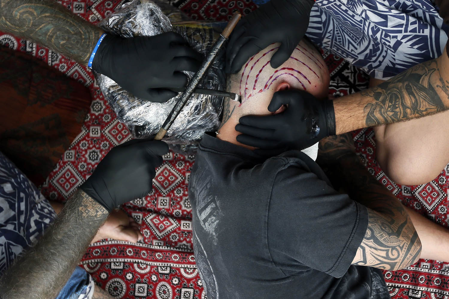 Sept. 27, 2013. A man is tattooed by  artist Brent McCown (L) during the ninth London Tattoo Convention in London.