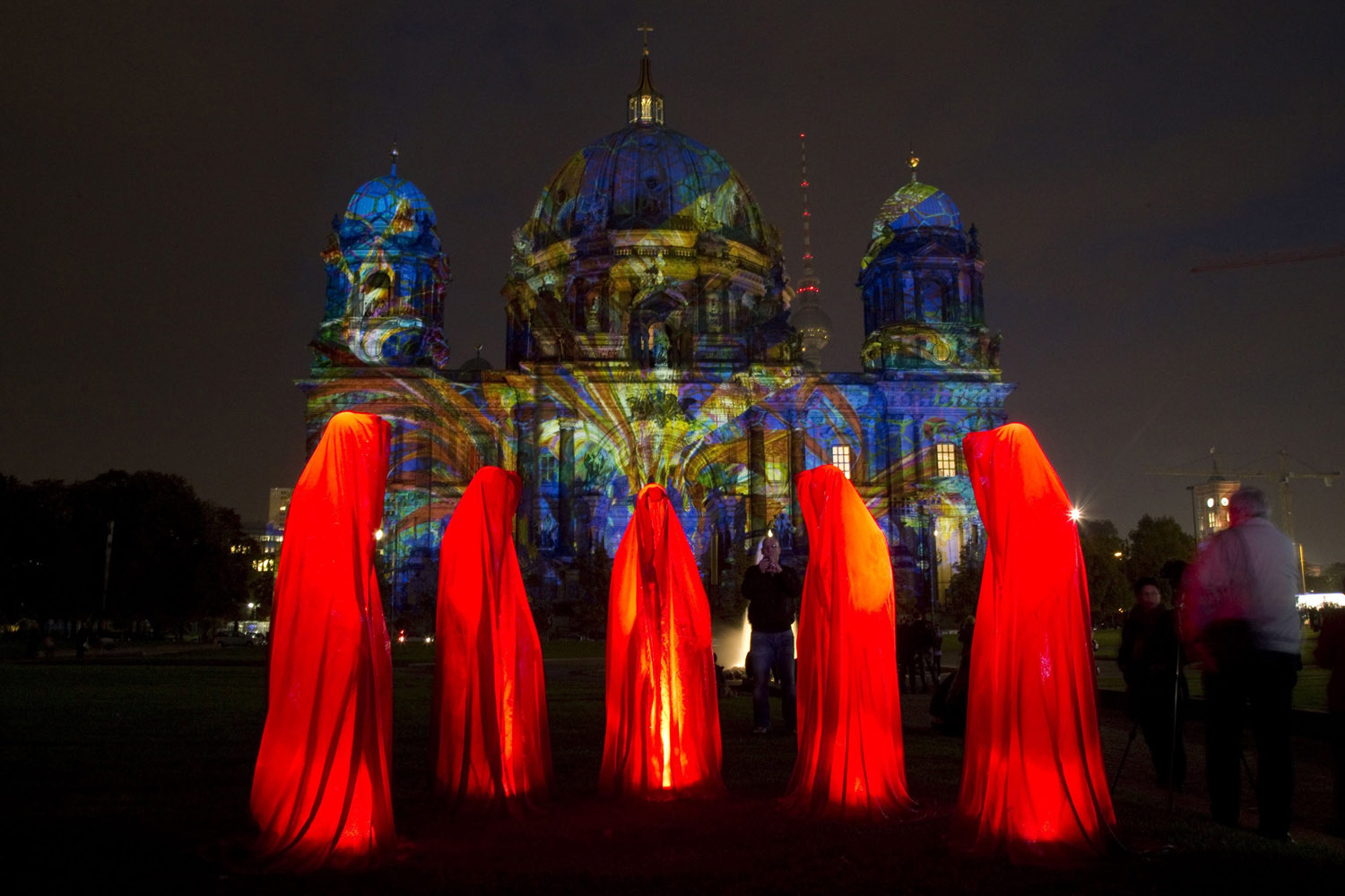 People look at a light installation during the opening day of the "Festival of Light" show in Berlin