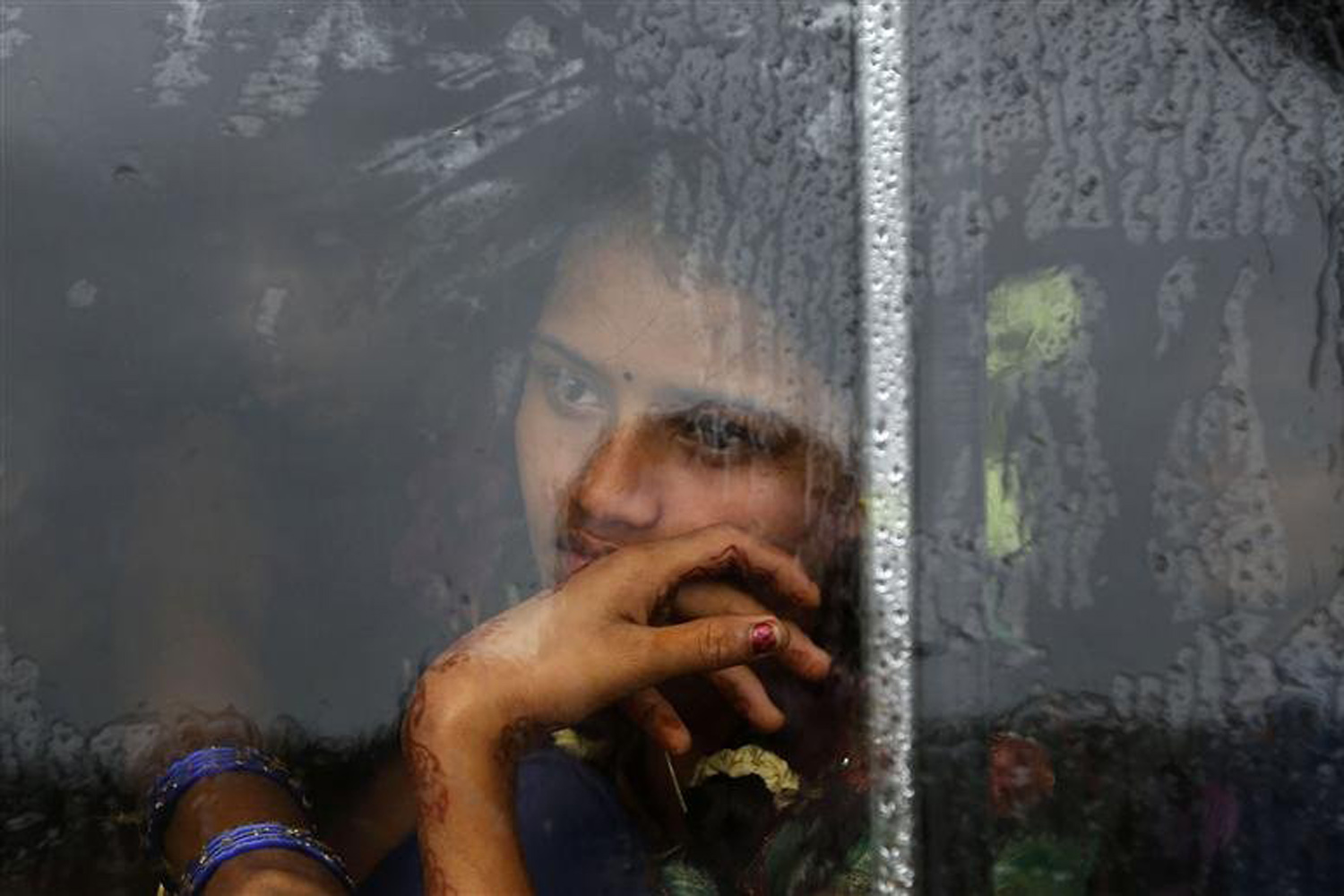 A girl looks out from the window of a bus travelling towards a relief camp in Donkuru