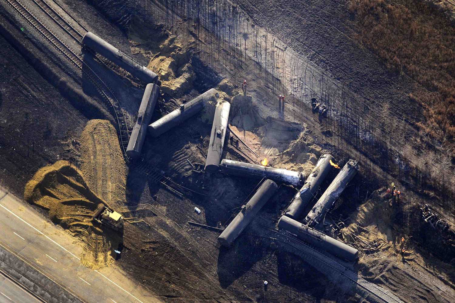 Oct. 20, 2013. Investigators survey the site of a train derailment near the hamlet of Gainford, west of Edmonton, Canada.