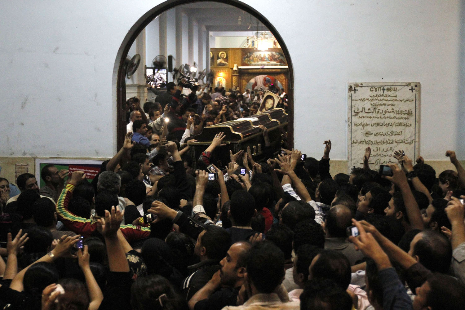 Oct. 21, 2013.  Relatives of four victims killed in an attack at a wedding attend their funerals at Virgin Church in Cairo.