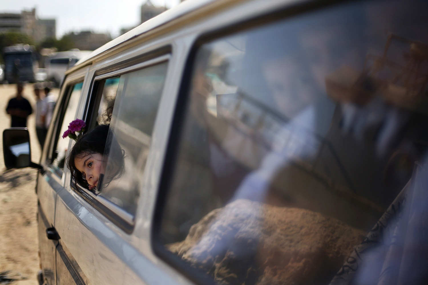 Palestinian schoolchildren sit in a bus after throwing flowers into the Seaport of Gaza City