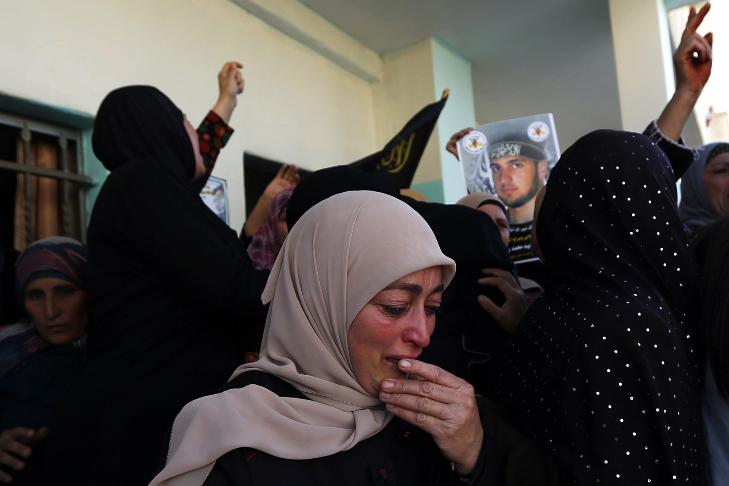 A Palestinian woman mourns during the funeral of Mohammed Assi near Ramallah