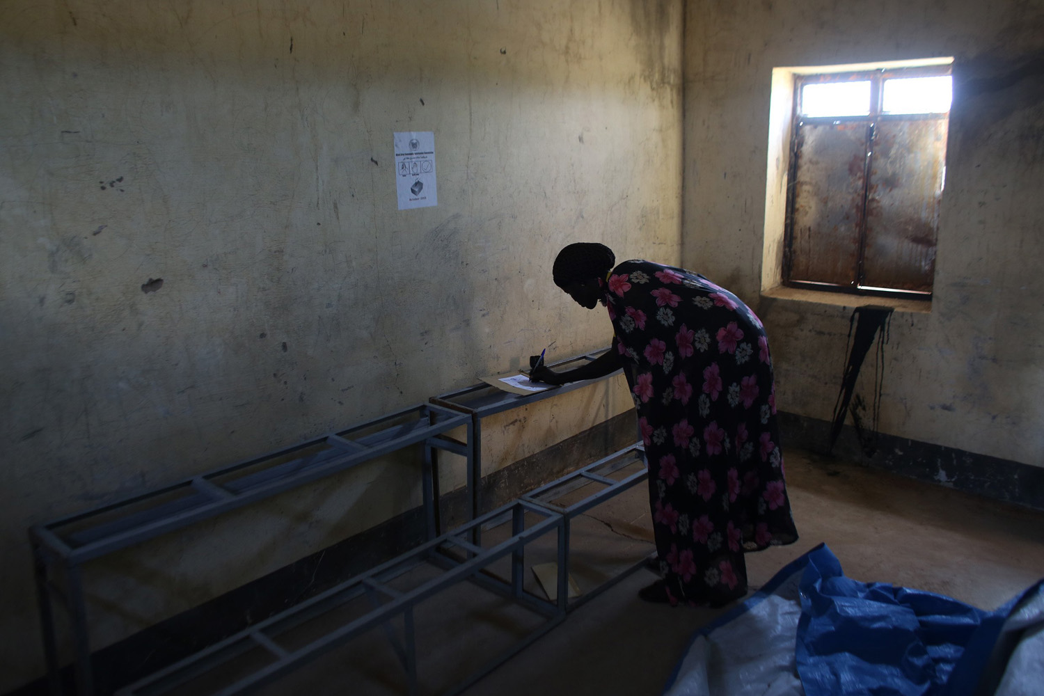 A woman votes in a polling station located in a school during a referendum in the town of Abyei