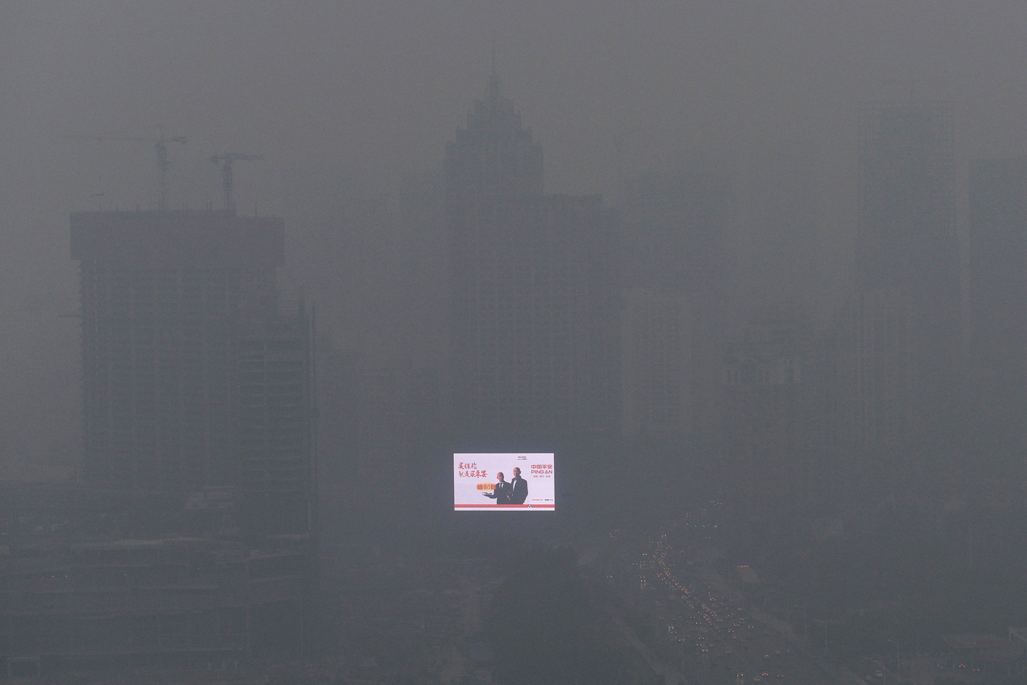 Oct. 28, 2013. An electronic screen is seen on a building amid heavy smog in Shenyang, Liaoning province, China.