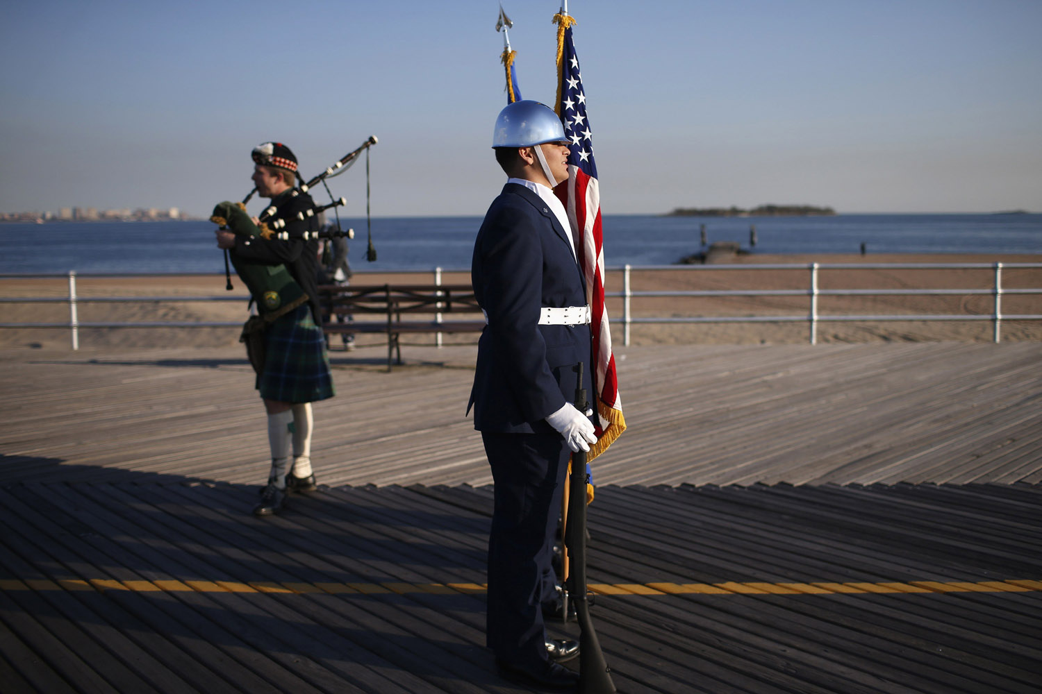 Oct. 29, 2013. A guard and bagpipe player stand on the boardwalk on the south shore of Staten Island in New York City during an event to commemorate the one-year anniversary of Hurricane Sandy.