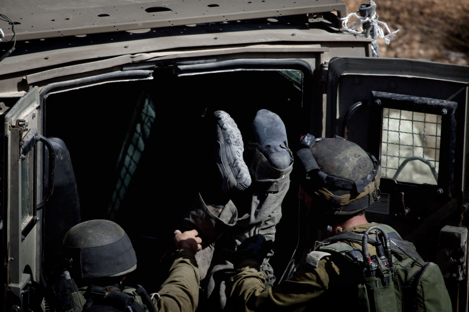 Oct. 22, 2013. Israeli soldiers load the body of slain Palestinian Islamic Jihad militant Mohamed Aatzi into an army vehicle in the village of Bilin near the West Bank city of Ramallah.