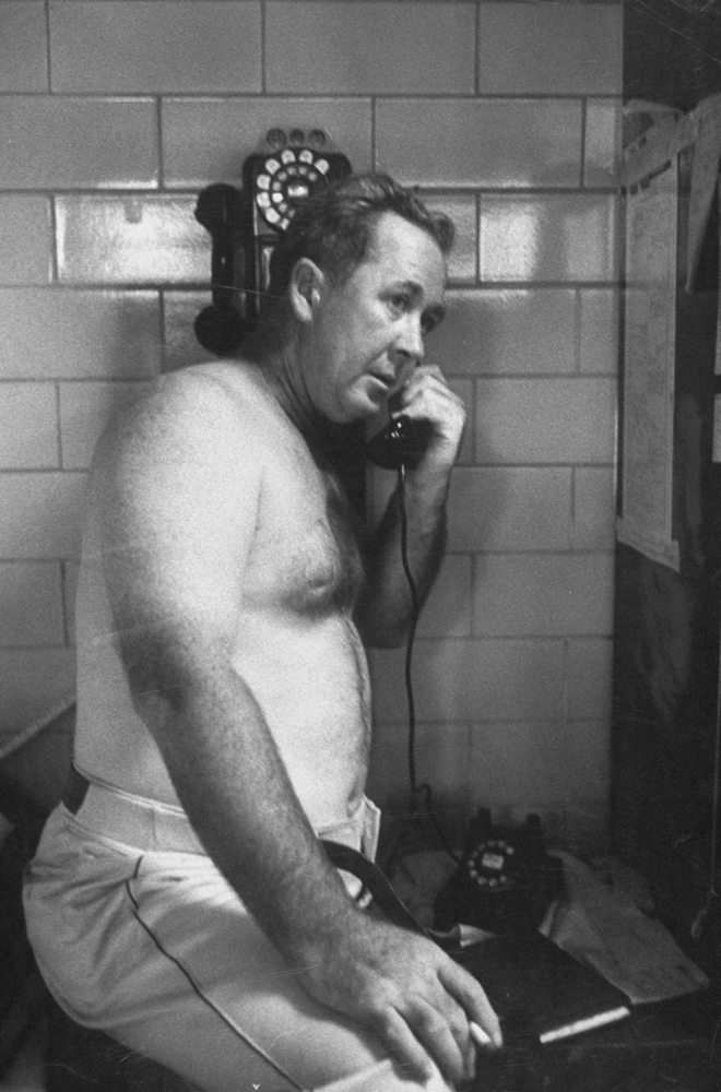 Cincinnati Reds manager Birdie Tebbetts, the Baseball Writers Association Manager of the Year, talks on the phone in the locker room during a Labor Day doubleheader against the Milwaukee Braves in 1956.