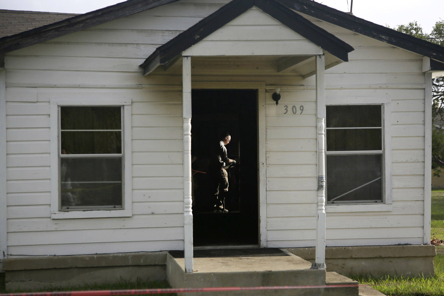 Oct. 29, 2013. Law enforcement official search inside the home of Mary Brownlow, a victim of arson, in Terrell, Texas.