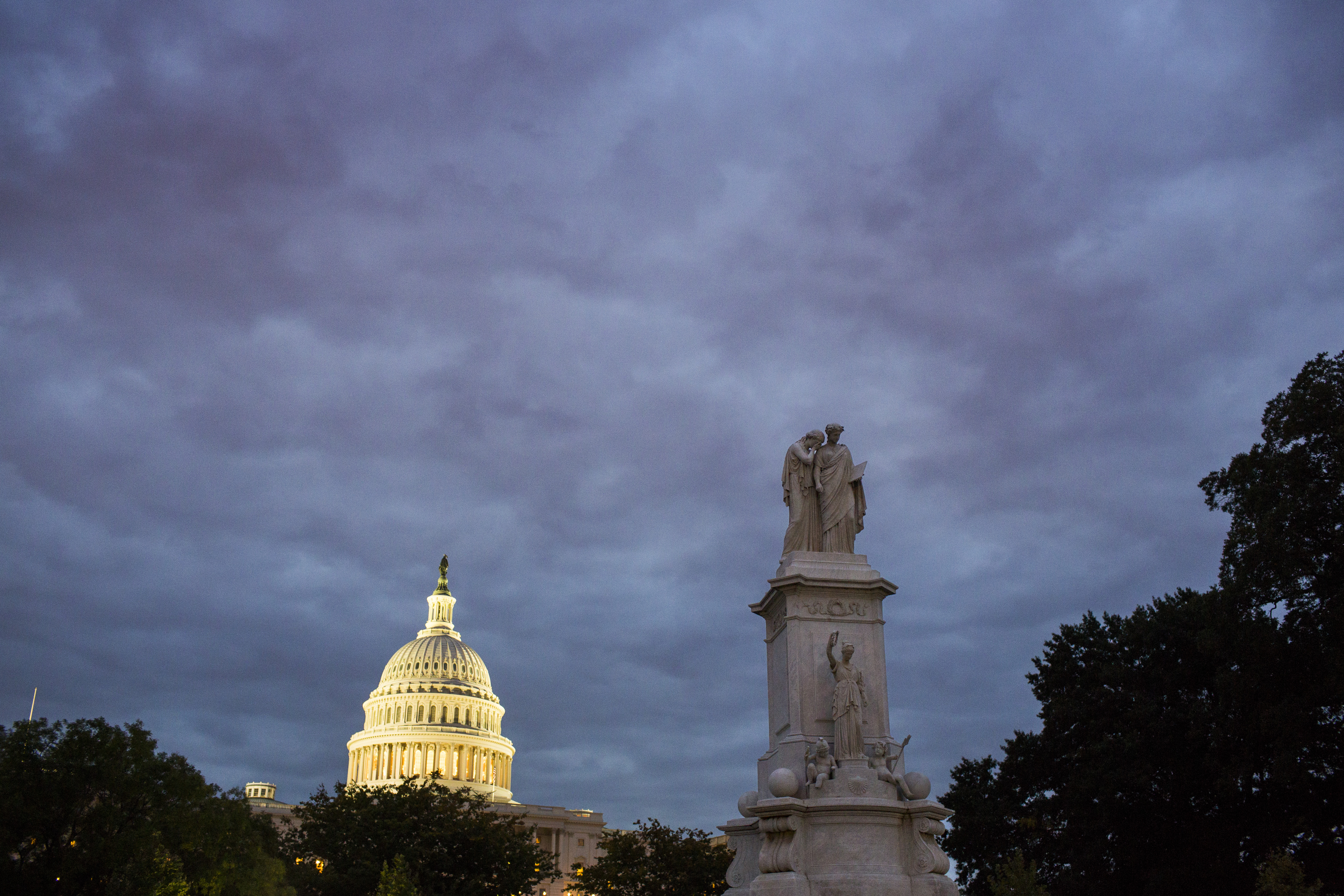 The sun rises on the U.S. Capitol and the Peace Monument in Washington, Oct. 1, 2013. Midnight marked the beginning of the first federal government shutdown since 1996.
