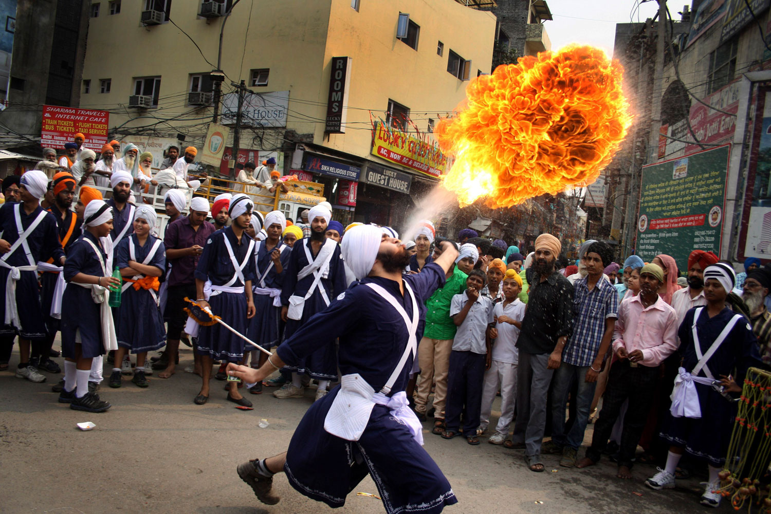 Oct. 8, 2013. A Sikh youth breathes fire during a religious procession on the eve of Guru Ram Das's birthday in Amritsar, India.