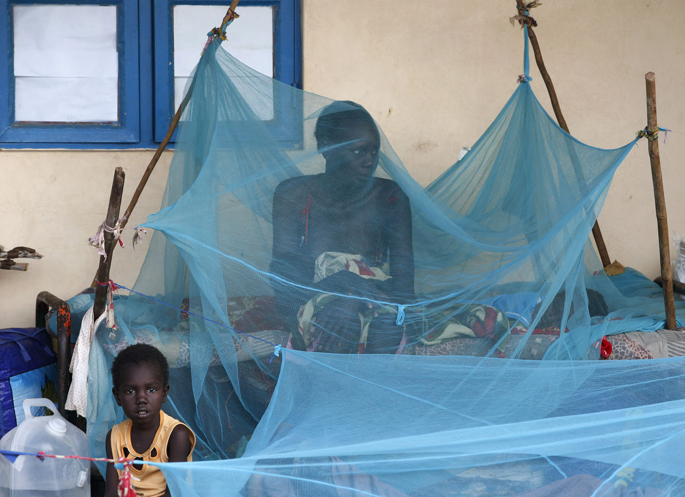 A woman feeds her child in a school near a polling station during a referendum in the town of Abyei