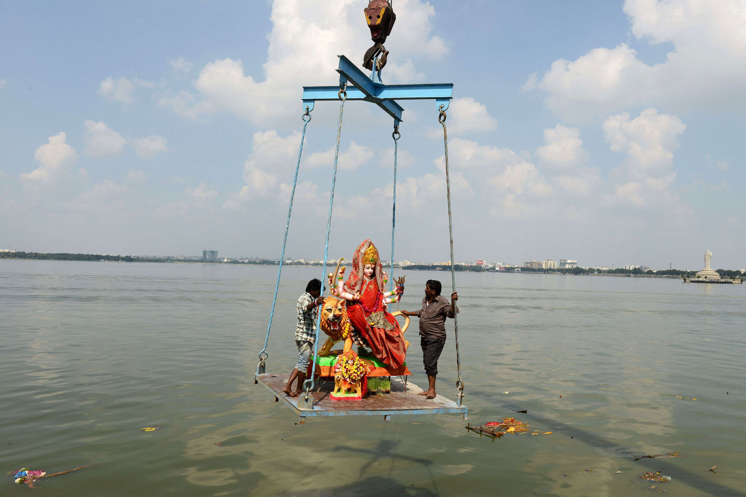 Indian workers immerse an idol of Hindu goddess Durga in the Hussainsagar lake on the occasion of the Dussehra-Vijaya Dashami Festival in Hyderabad.