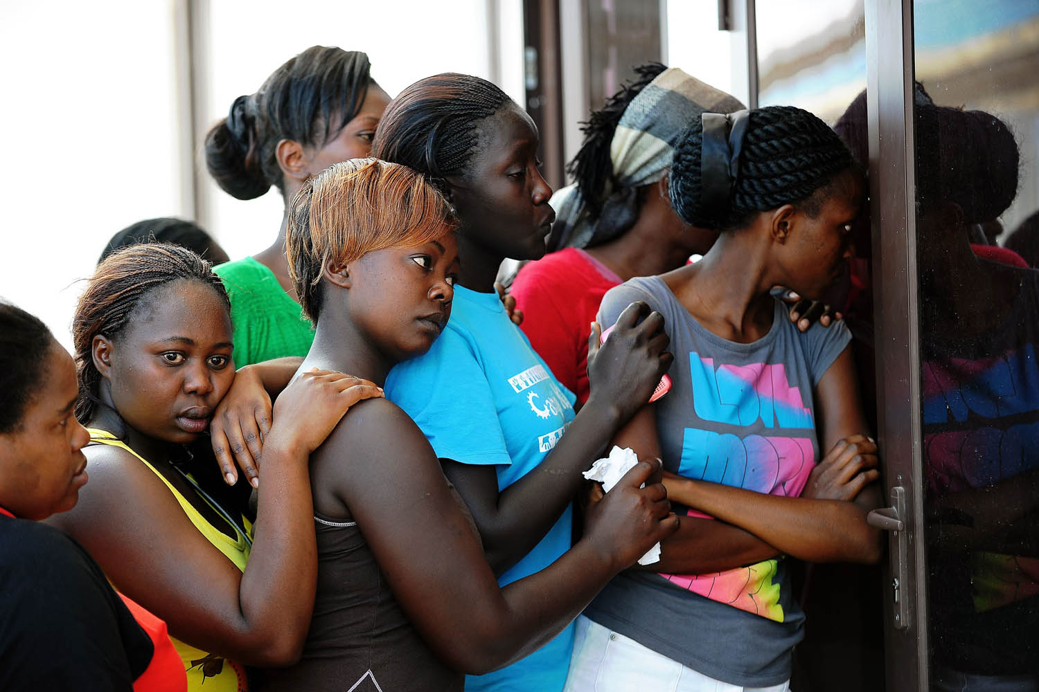 Oct. 30, 2013. 
                              Mourners gather after a train rammed into a public service bus in Nairobi, Kenya.