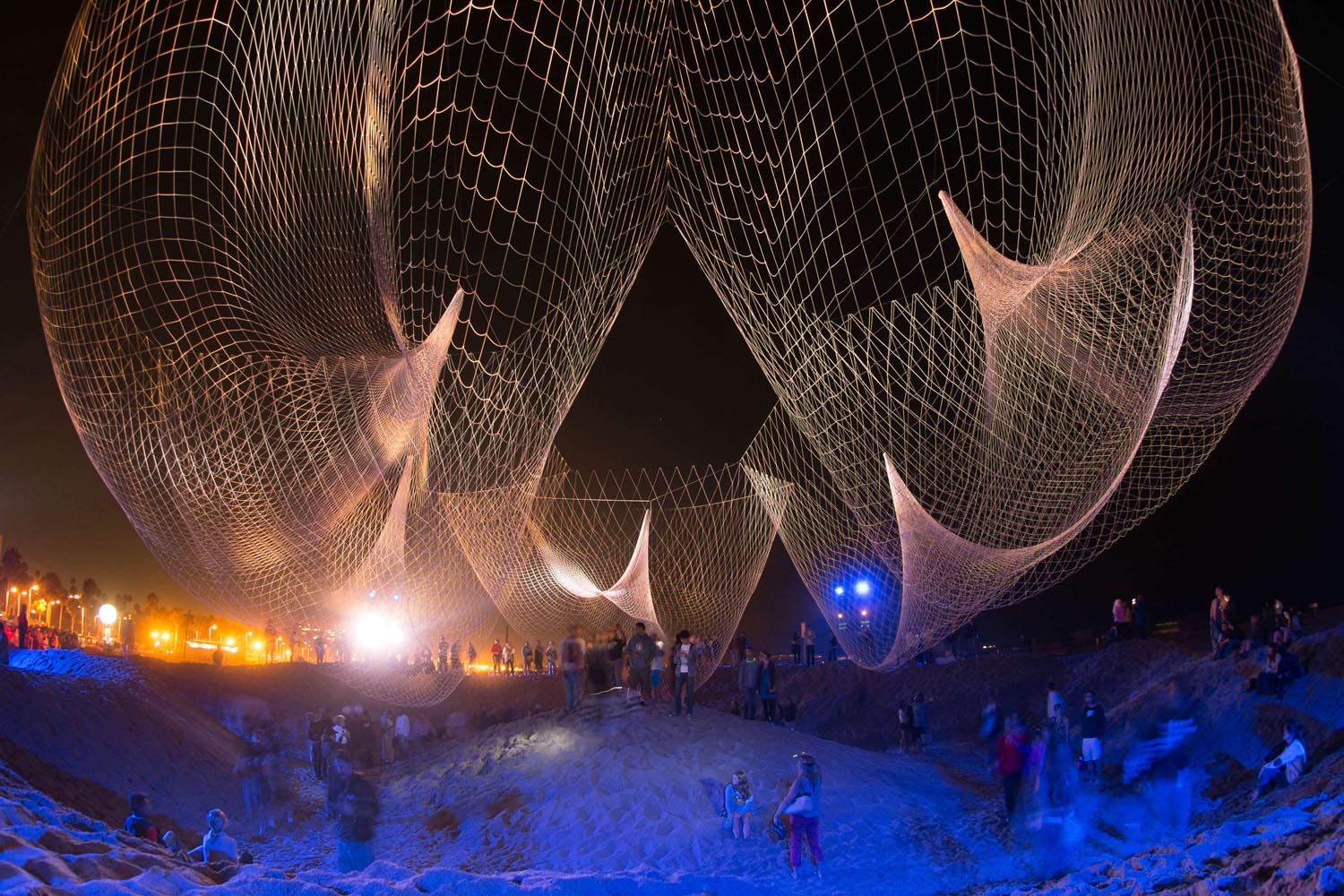 Sept. 29, 2013. Visitors explore the creation of artist Janet Echelman 'The Space Between Us' during Glow 2013 at the beach in Santa Monica, Calif.