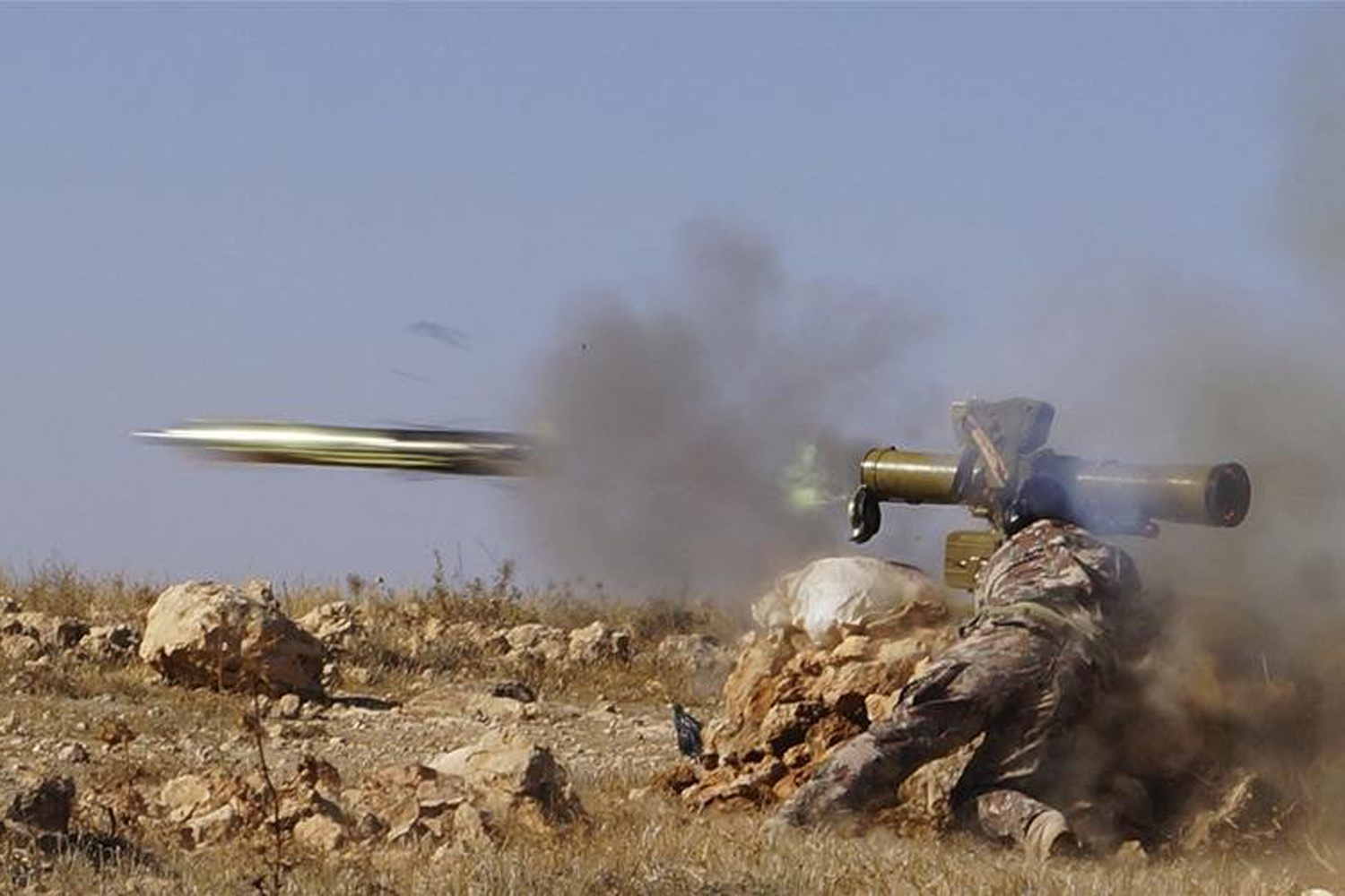 A Free Syrian Army fighter fire an anti-tank missile towards what the FSA said were locations controlled by forces loyal to Syria's President Bashar al-Assad in the eastern Hama countryside