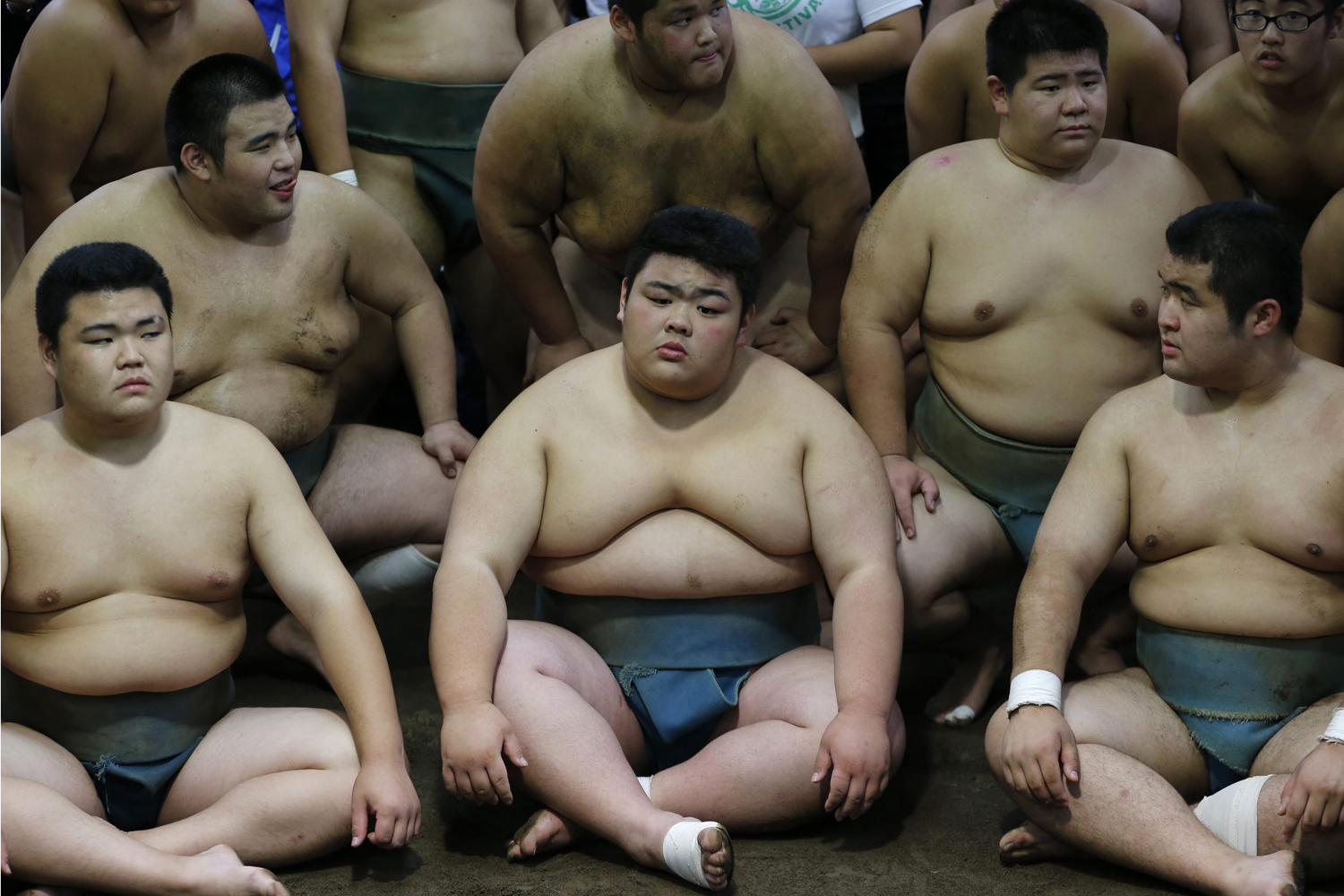 Oct. 25, 2013. Traditional sumo wrestling club members at Saitama Sakae junior and senior high school prepare for a photo session with cyclists including Tour de France winner Christopher Froome of Britain in Saitama, north of Tokyo.