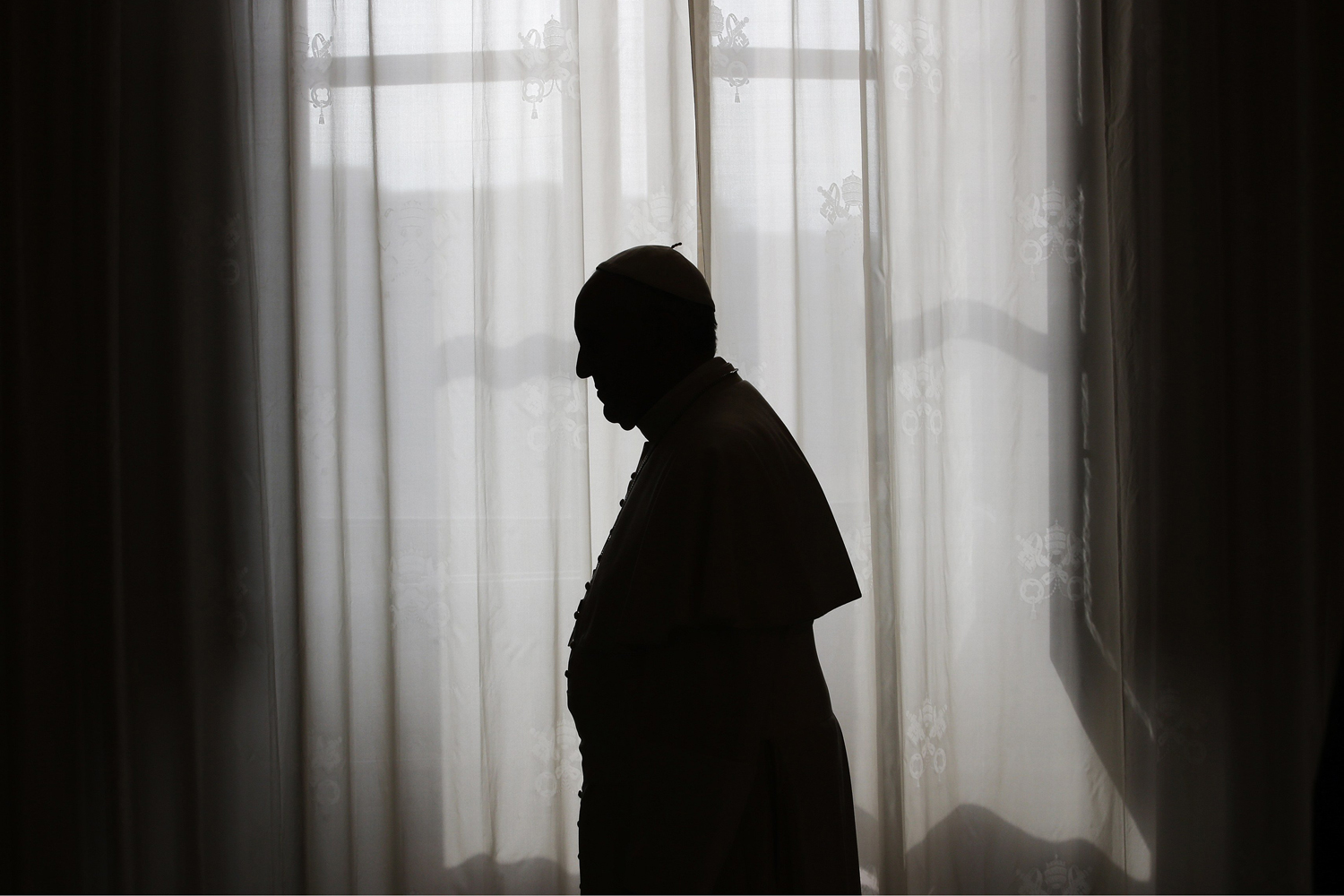 Oct. 25, 2013. Pope Francis is silhouetted against window light at the end of a meeting with Equatorial Guinea's President Teodoro Obiang Nguema Mbasogo at the Vatican.