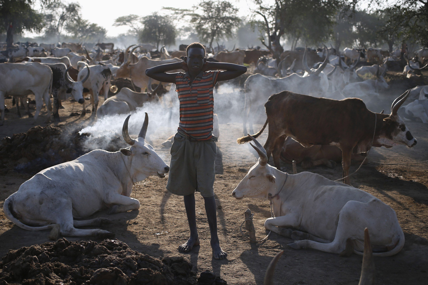A young man from Dinka Ngok tribe stands in a cattle herders' camp near the town of Abyei