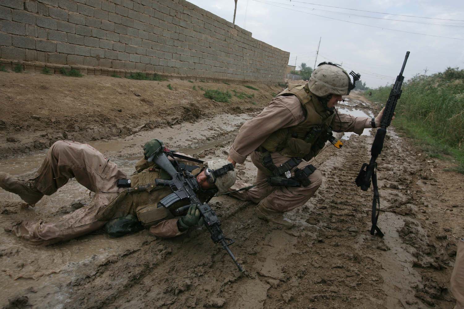 PLS HOLD UNTIL FAMILY IS NOTIFIED: Iraq: Karmah: October 31, 2006: Sgt Jesse E. Leach drags Lance CPL Juan Valdez of the for 4th mobile assault platoon Weapons company 2nd battalion 8th Marines to safety moments after he was shot by a sniper during a joined patrol with the Iraqi Army in Karmah, Anbar Province, Iraq. Valdez was shot through the arm and the right side but survuved. Photo: Joao Silva was shot by a sniper while on a patrol