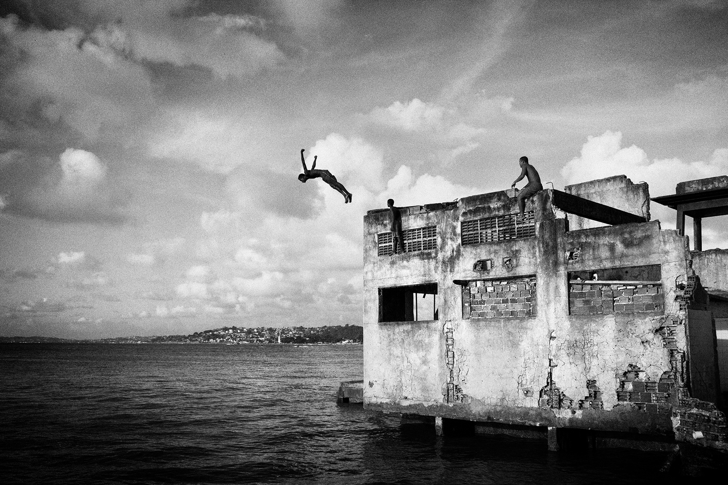 SALVADOR DE BAHIA, BRAZIL – MARCH 20, 2011: A boy jumping from a building of the abandonated chocolate factory, on March 20, 2011 in Salvador de Bahia, Brazil. Despite the lack of socio-economic support from the government, they have managed to make a safe place for themselves to live, and form a community of their own, which is safer that the alternatives available to them. However they are currently being evicted by the government due to being there illegally. (Photo by Sebastian Liste/Reportage by Getty Images)
