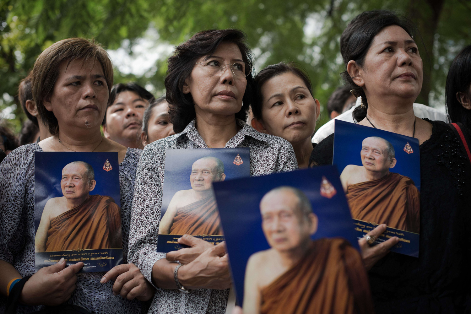 Oct. 25, 2013. Thai women hold a portrait of Thai Supreme Patriarch Somdet Phra Nyanasamvara, Thailand's top Buddhist leader who died at the age of 100, outside the Chulalongkorn hospital, in Bangkok.
