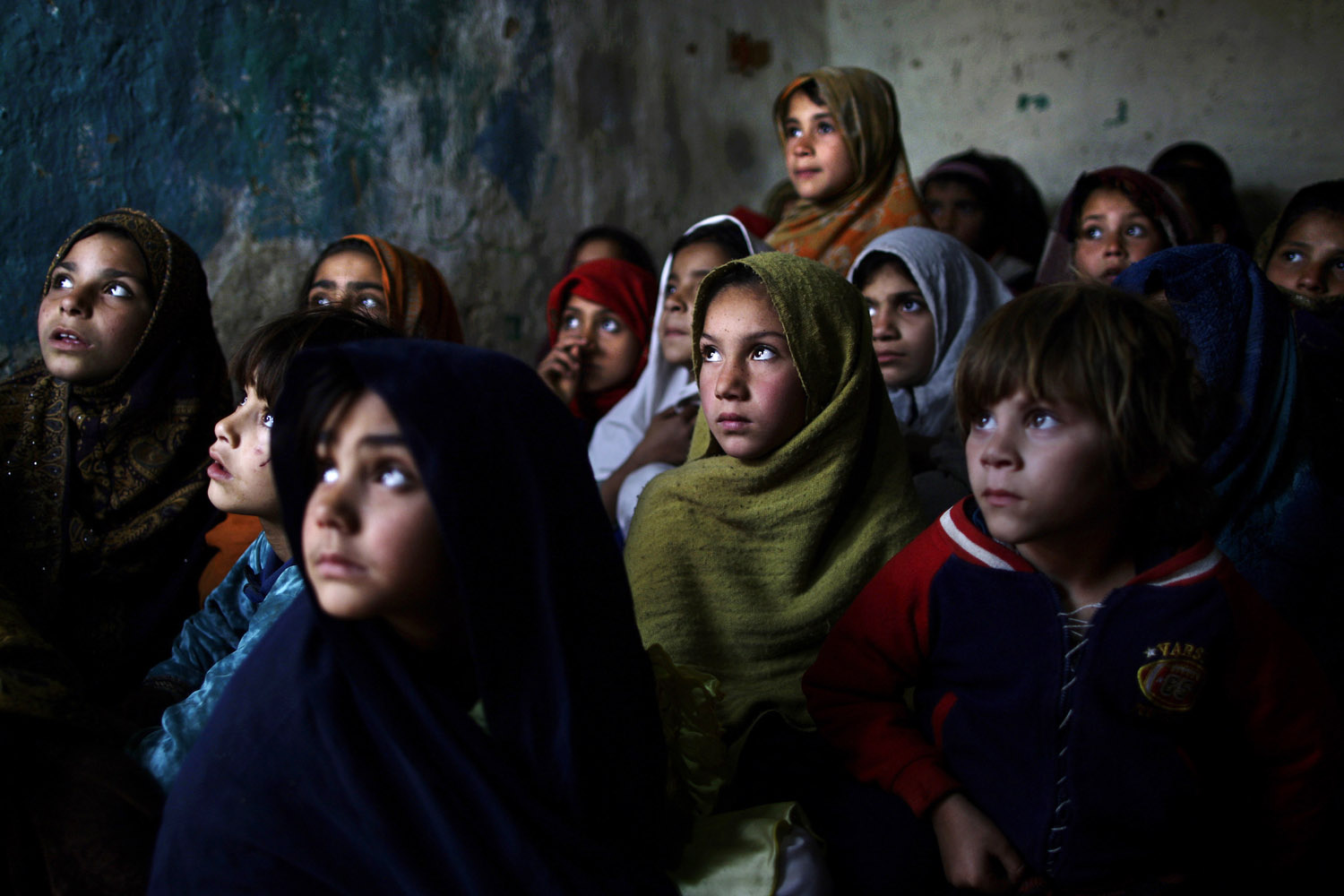 Jan. 31, 2013. Pakistani schoolgirls who were displaced with their families from Pakistan's tribal areas due to fighting between militants and the army listen to their teacher in a poor neighborhood on the outskirts of Islamabad.