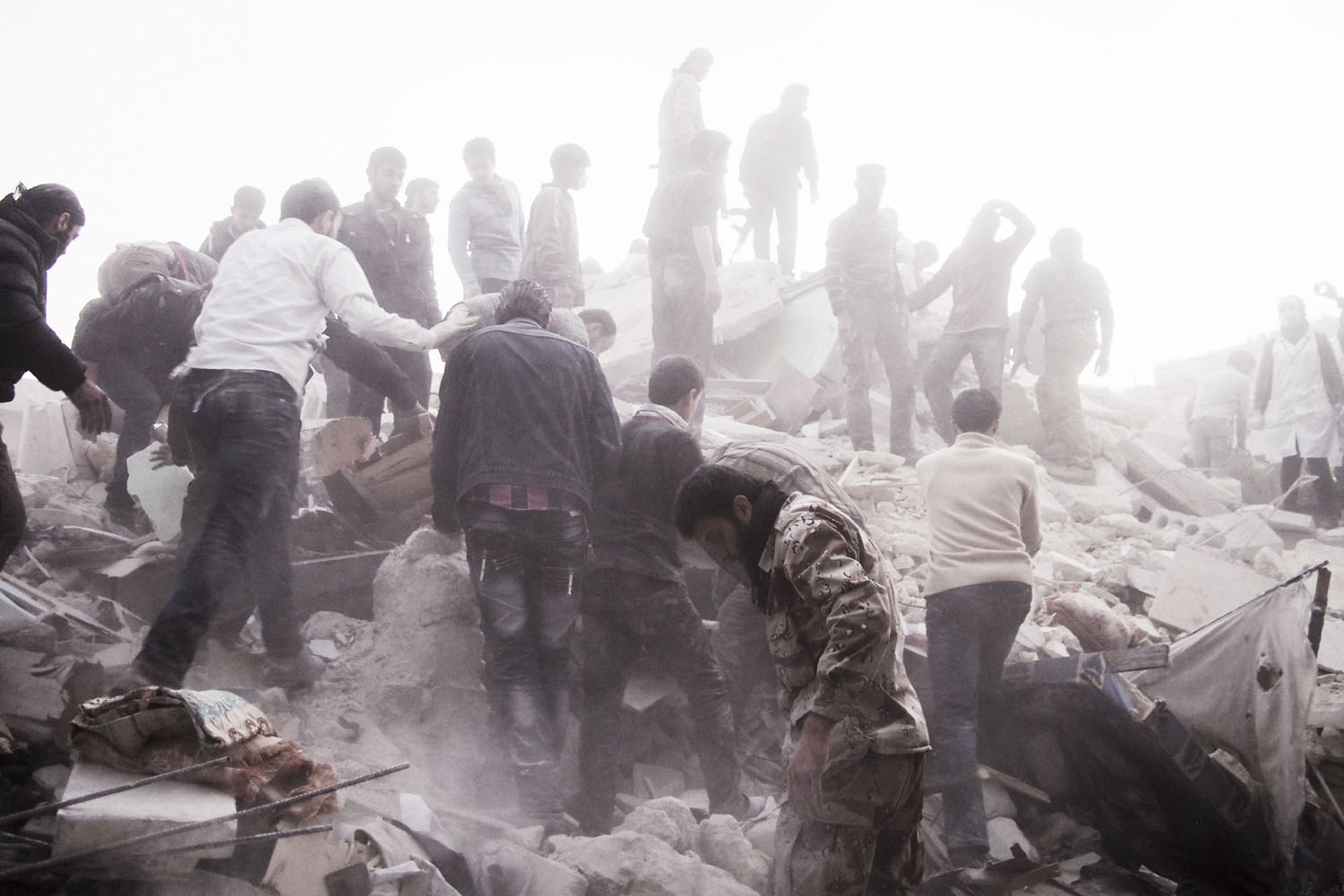 SYRIA. Aleppo. March 19, 2013. Searching for survivors among the rubble of a residential building targeted by a regime airstrike in the rebel-held Al-Sukri district.