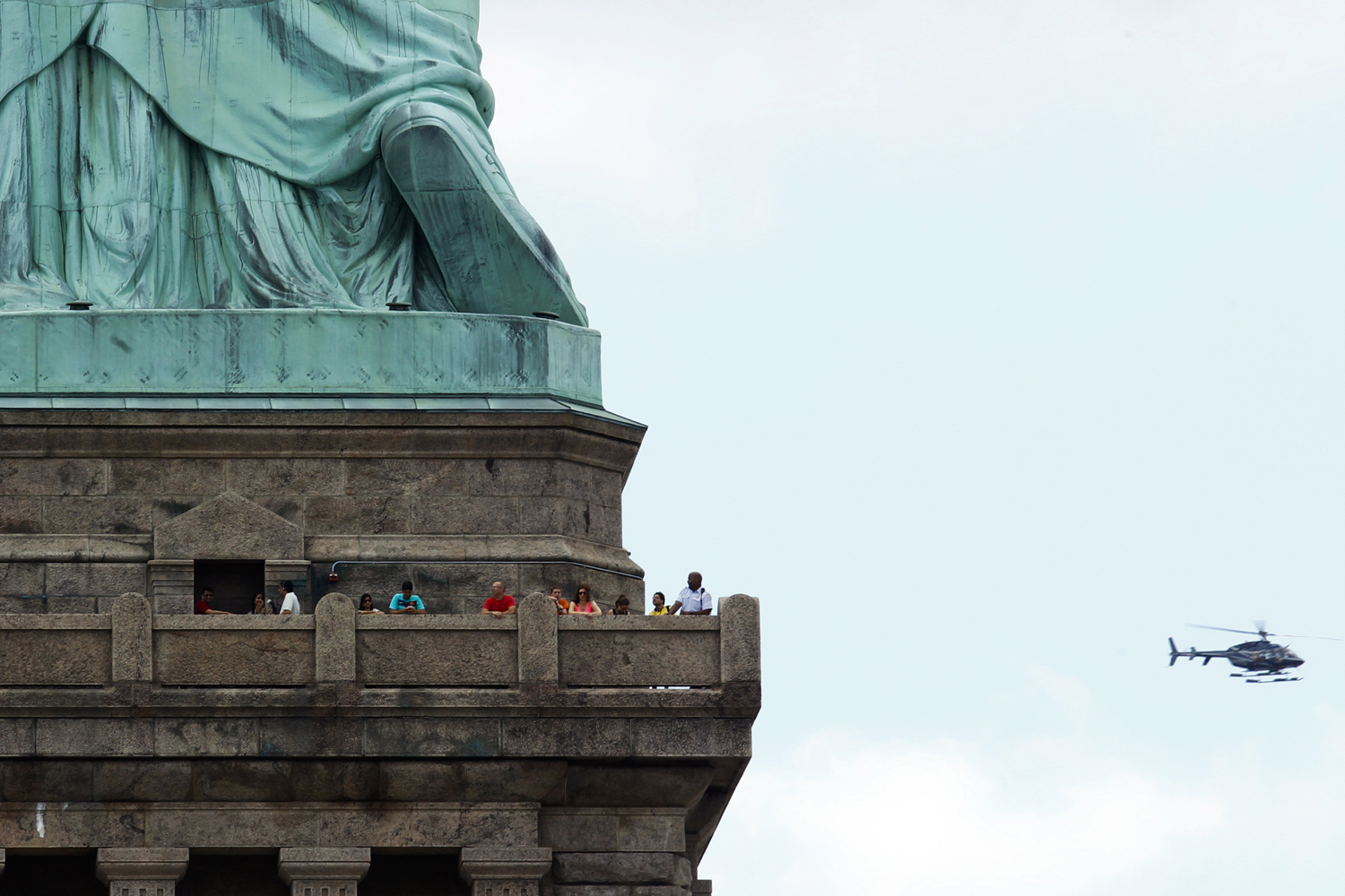 People visit the Statue of Liberty during the reopening ceremony in New York