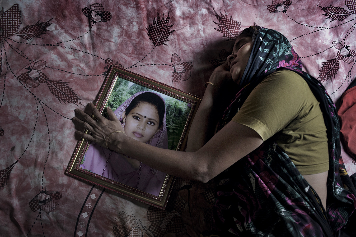 June 1, 2013. The mother of garment worker Poly Akther weeps over her loss, Dhaka, Bangladesh.