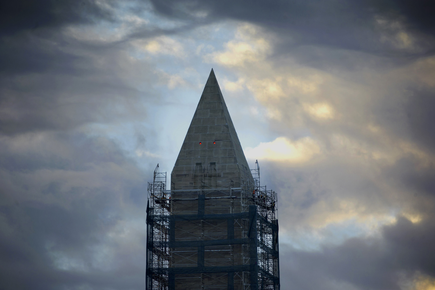 Nov. 18, 2013. Work crews continue removing the scaffolding surrounding the Washington Monument in Washington.