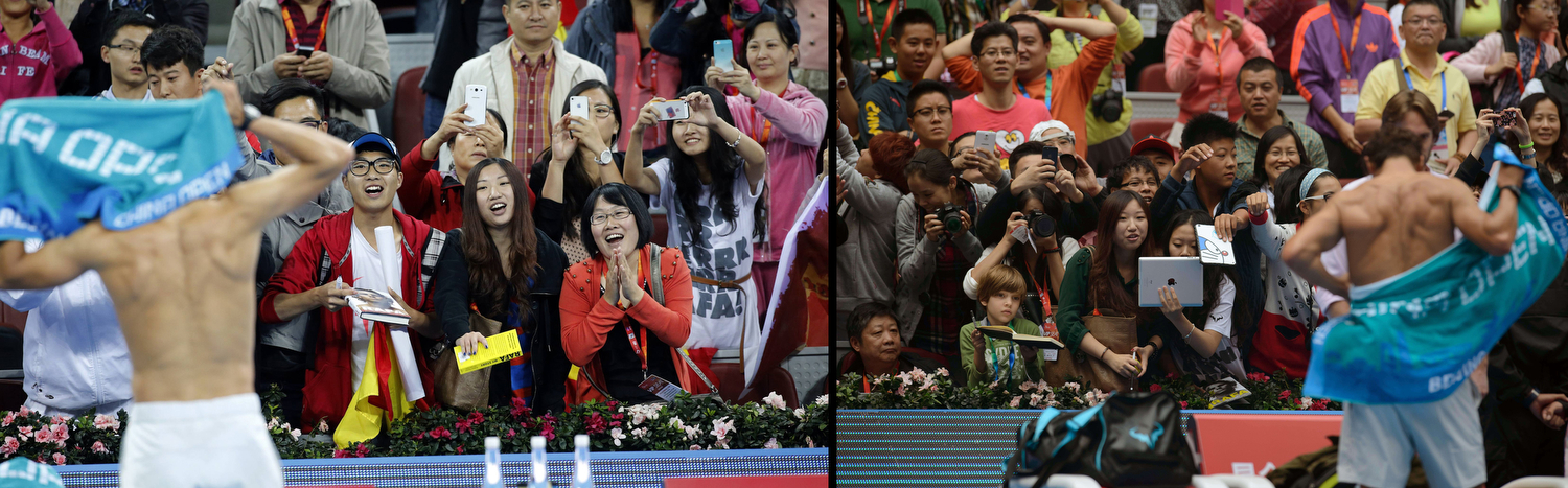 Fans watch Spain's Rafael Nadal change his shirt after he defeated Philipp Kohlschreiber of Germany in their match at the China Open tennis tournament in Beijing
