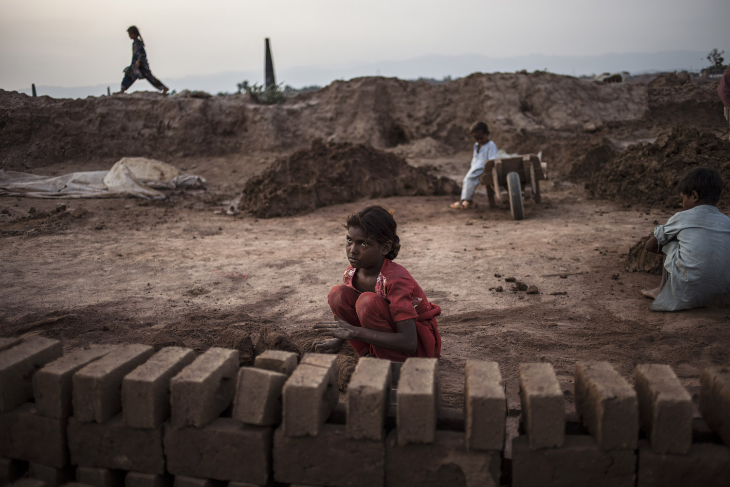 June 12, 2013. Shimraz Younis, 10, prepares clay while working at a brick factory on World Day Against Child Labor, in the outskirts of Islamabad. Shimraz earns 200 Rupees ($2.03 USD) per day.