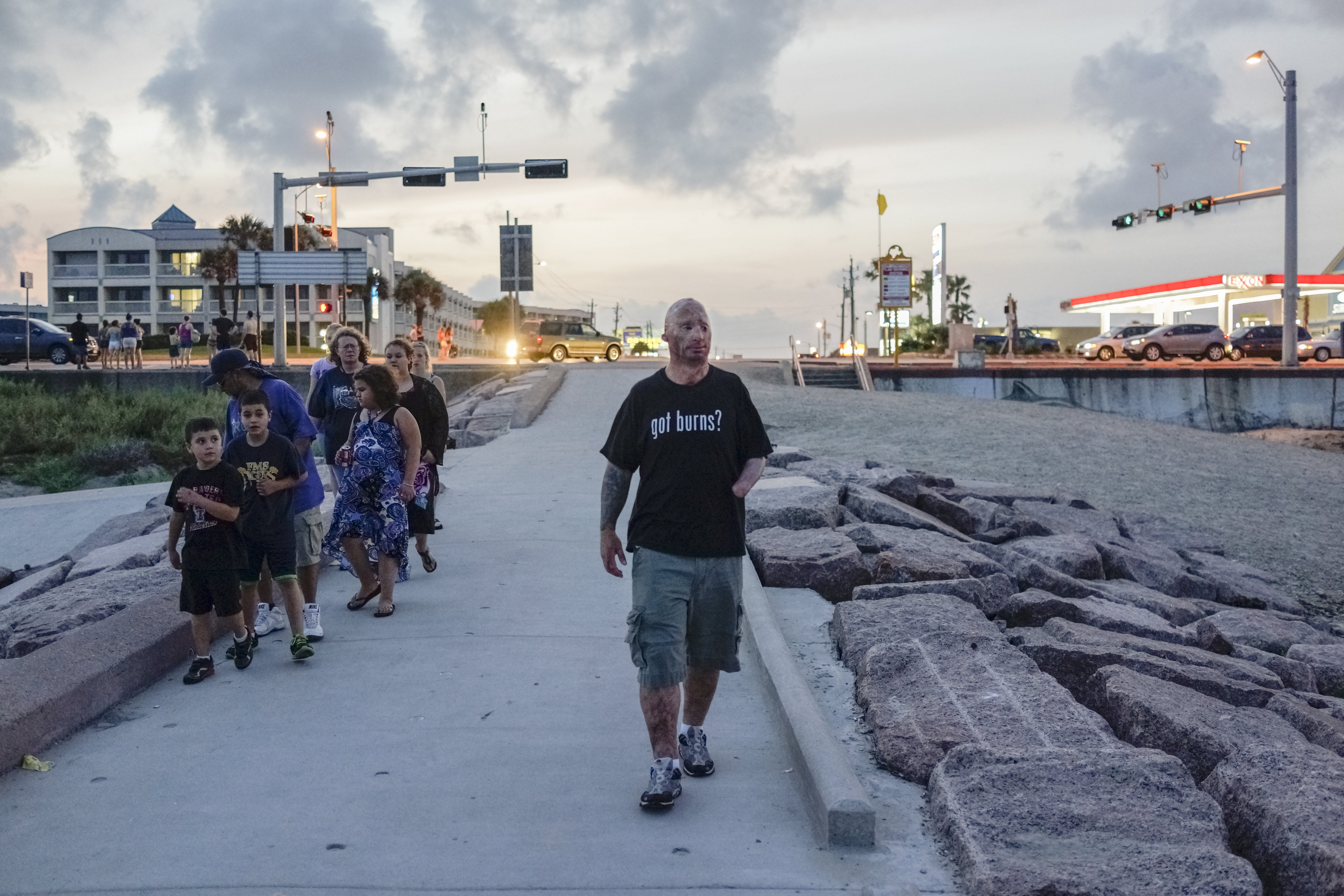 Bobby walks along the beach after visiting Grant, a 12-year old who was burned as a toddler. Grant was having surgery the next day, so Bobby visited him in his hotel in Galveston to cheer him up. 2013.