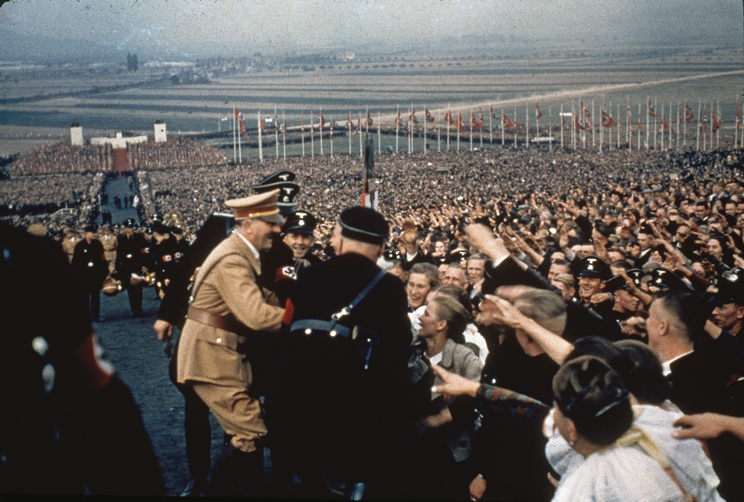 Adolf Hitler greets the cheering throng at a rally in 1937.