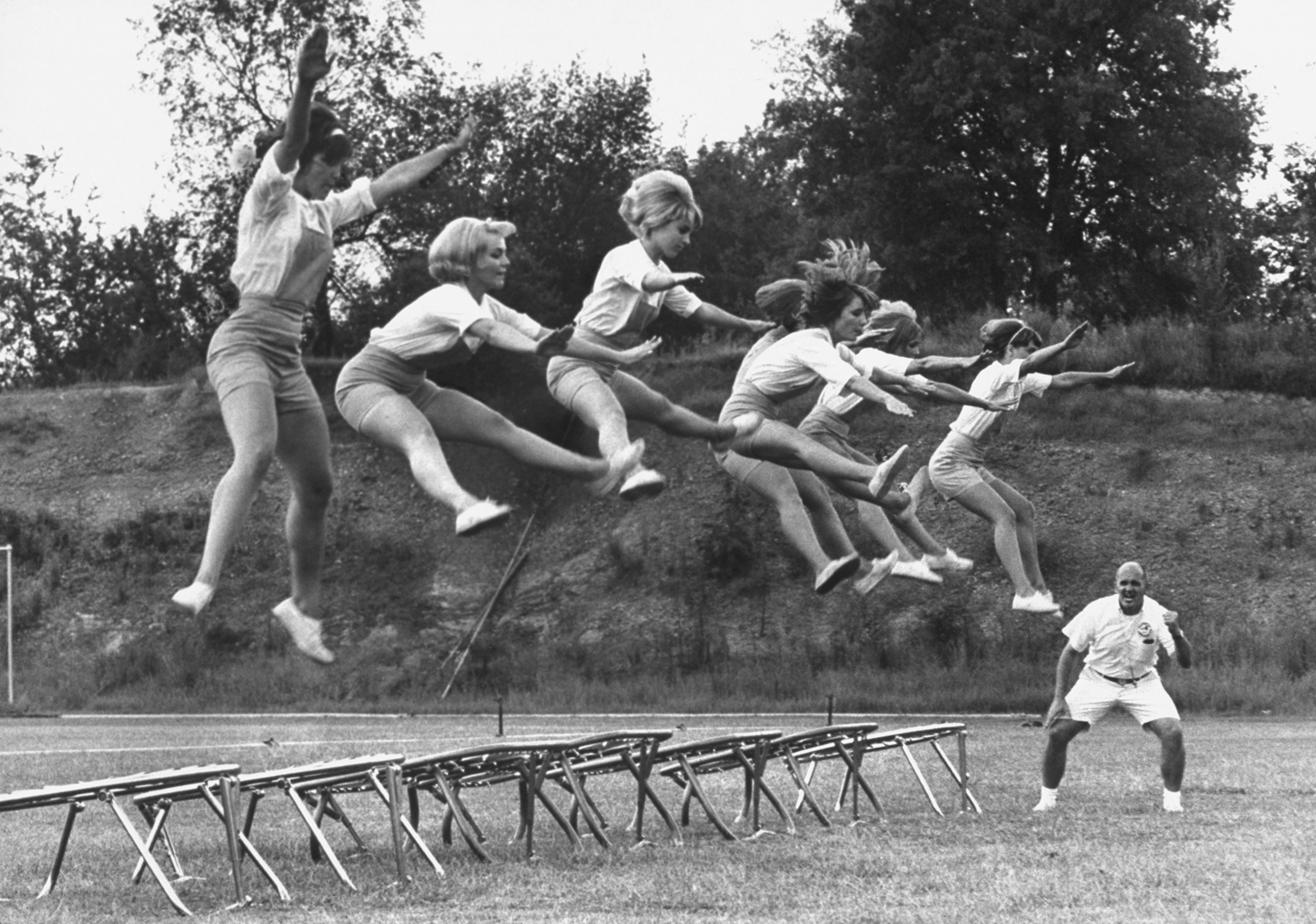 Cheerleader training under Bill Horan of the American Cheerleaders Association, Alabama, 1965. "Reach for the ripcord!" Horan bawls at his students.