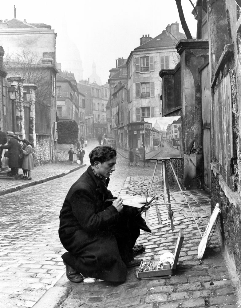 A young artist paints Sacre-Coeur from the ancient Rue Norvins in Montmartre, Paris, 1946.