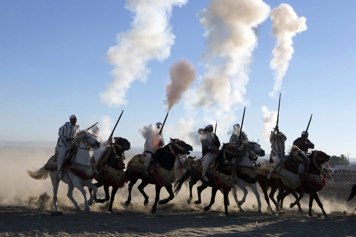 Horse riders perform with guns to celebrate the 38th anniversary of the now famous Green March on Wednesday near city of Fes