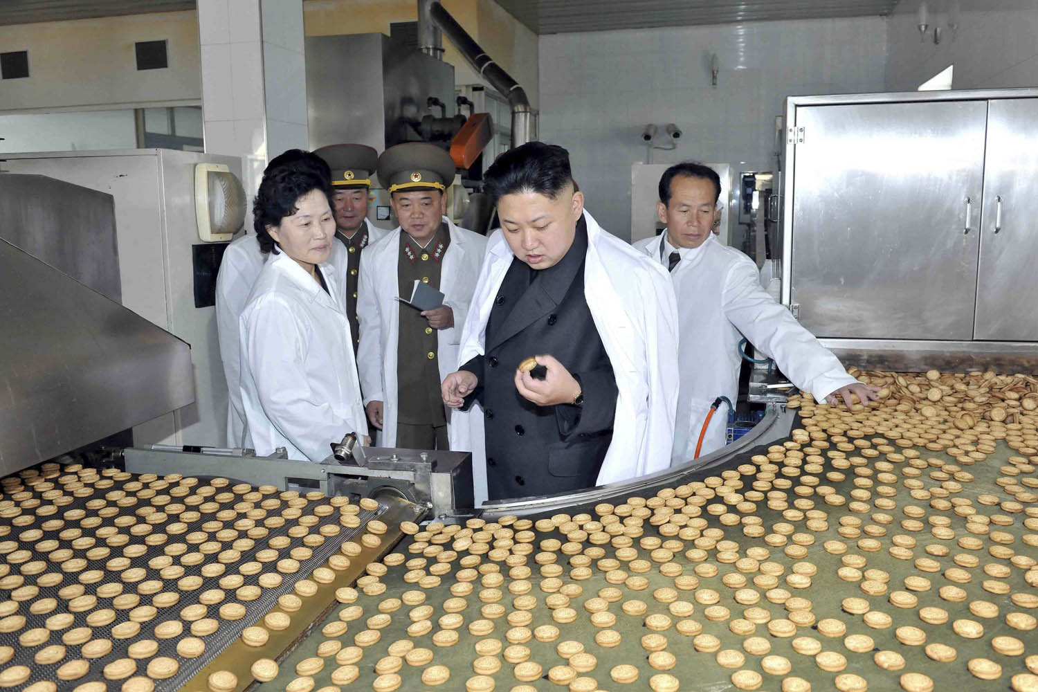 Nov. 17, 2013. North Korean leader Kim Jong Un looks at a biscuit as he provides field guidance at Foodstuff Factory No. 354 of the Korean People's Army in this undated photo released by North Korea's Korean Central News Agency (KCNA) in Pyongyang.