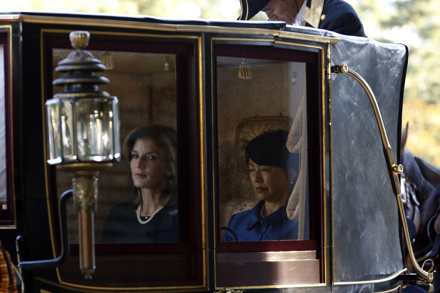 Nov. 19, 2013. Newly appointed U.S. ambassador to Japan Caroline Kennedy (C) is seen through a window of a horse-drawn carriage as she arrives at the Imperial Palace in Tokyo to present her credentials to Japan's Emperor Akihito.