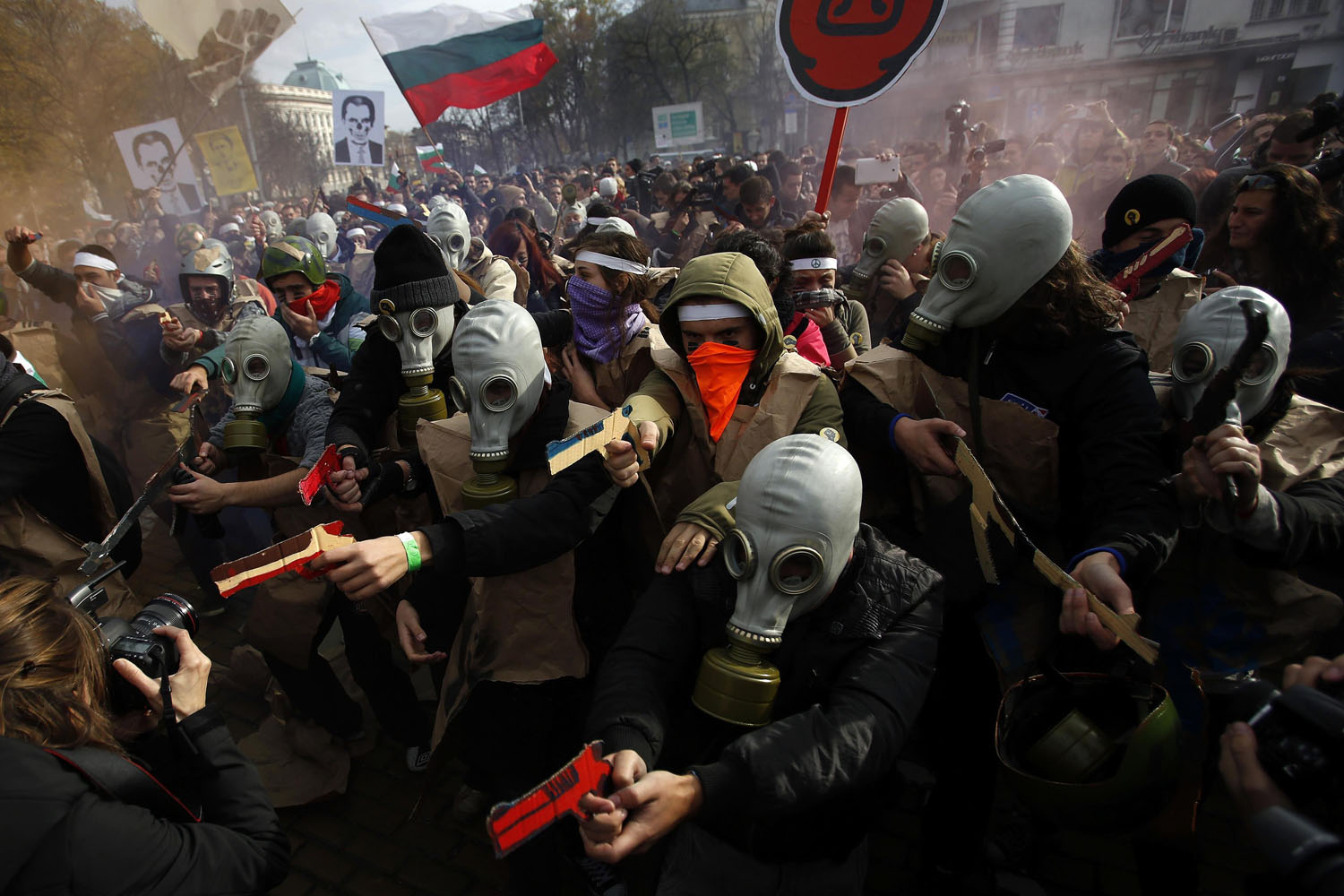Nov. 20, 2013. Protesting students wearing gas masks and carrying fake guns made of cardboard participate in a demonstration in front of the parliament in Sofia, Bulgaria.