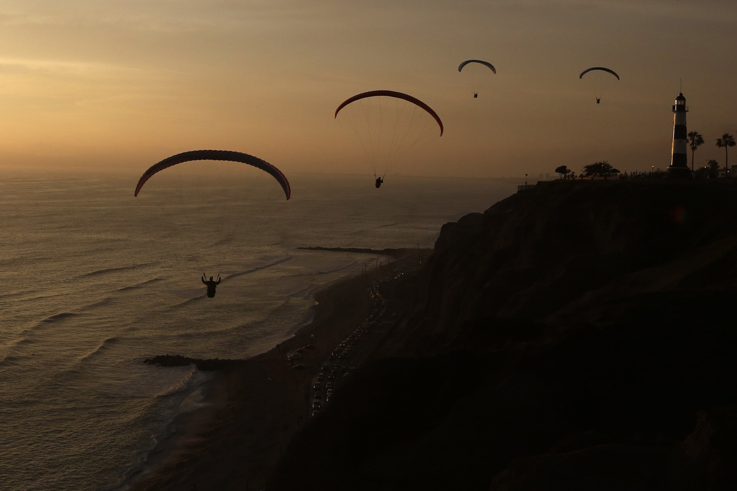 Paragliders fly in front of Lima's Miraflores district