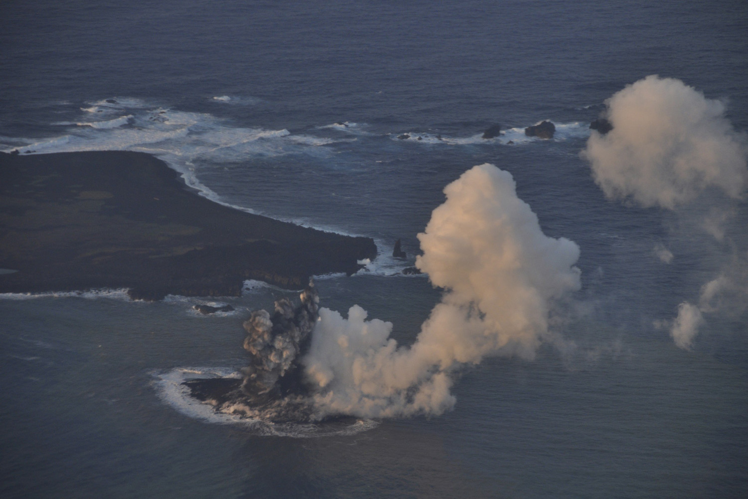 Smoke from an erupting undersea volcano forms a new island off the coast of Nishinoshima in the southern Ogasawara chain of islands