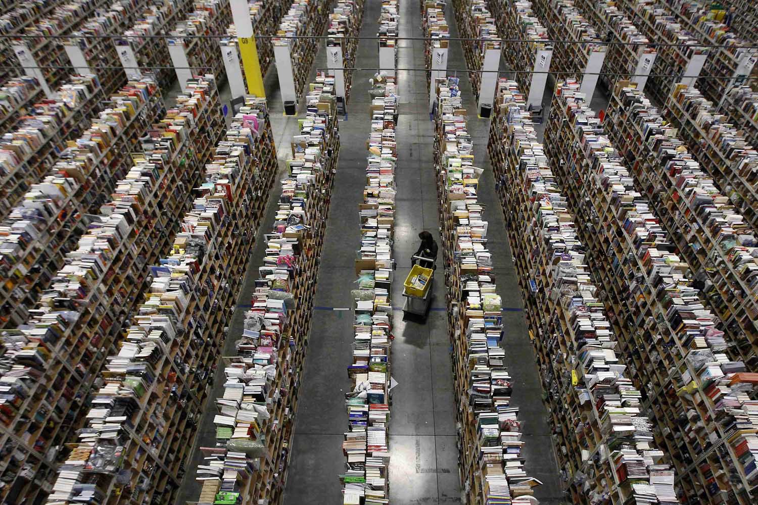 Worker gathers items for delivery at Amazon's distribution center in Phoenix